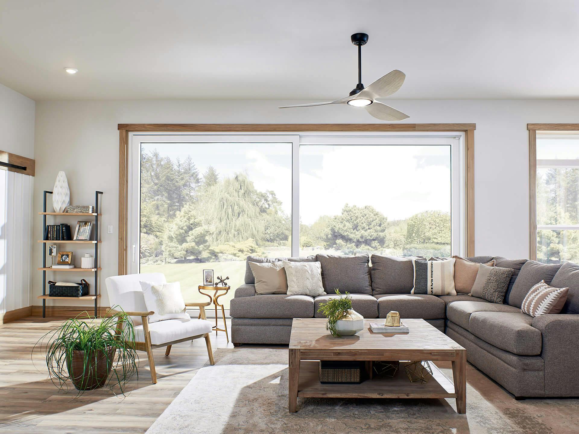 Living room with large sliding doors with lots of natural light, featuring an Imari ceiling fan
