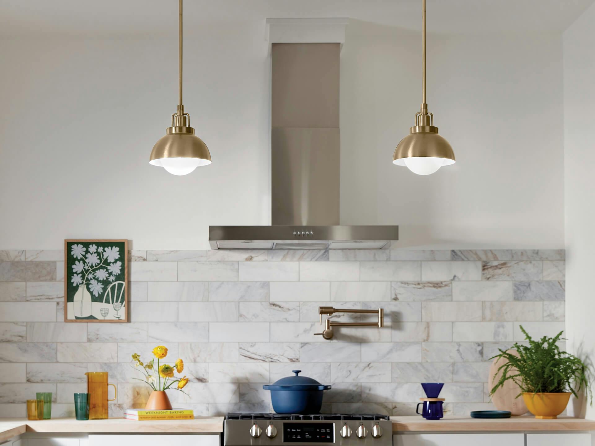 Kitchen featuring two Niva pendants in champagne bronze hangings on each side of the stove