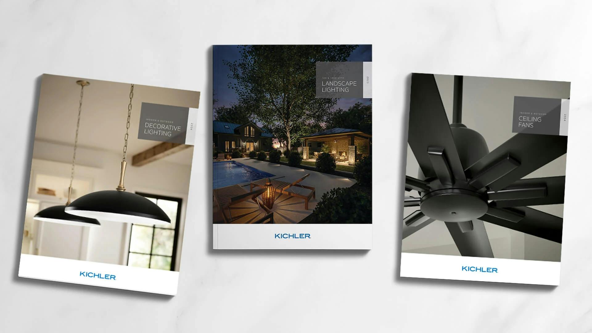 Three Kichler catalog covers featuring pendant lights, a lit outdoor scene and a ceiling fan.