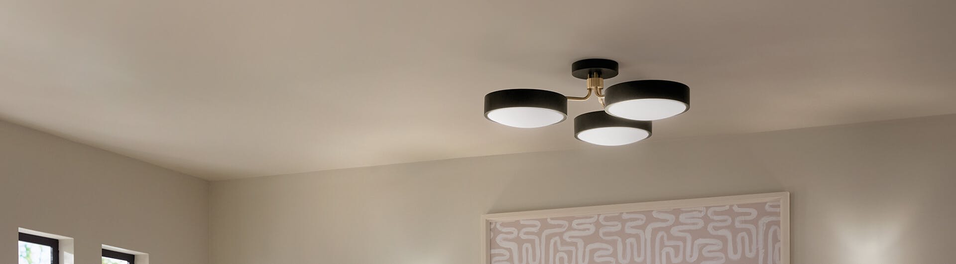Black, 3-light Sago semi-flush mount light on a daylit living room ceiling