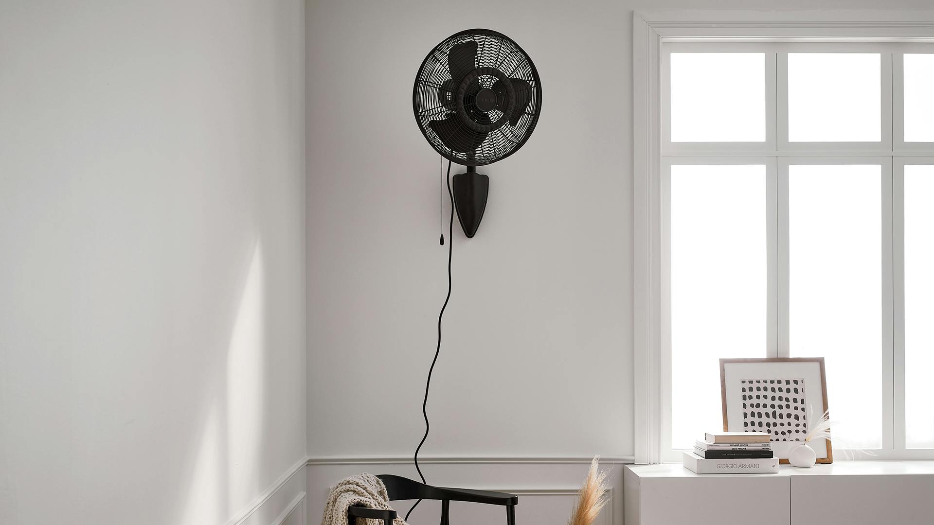 Pola wall fan in living room during the day.