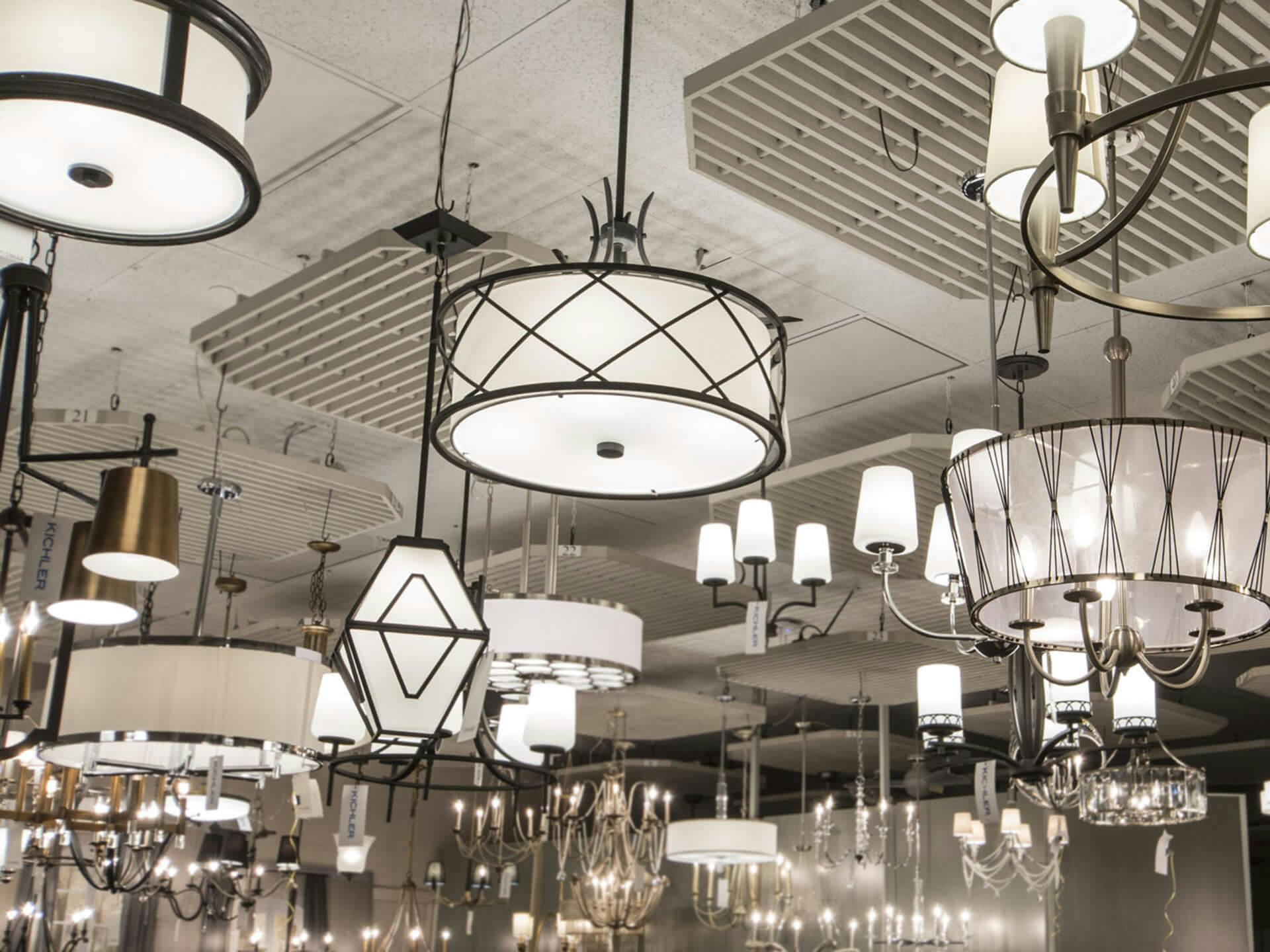 Photo of variety of chandelier lights hanging in a showroom ceiling