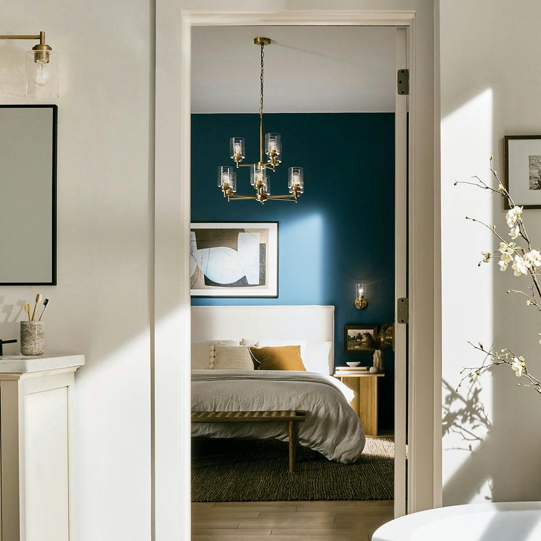 Bedroom in day light with the Winslow 27" 9-Light Chandelier in Natural Brass