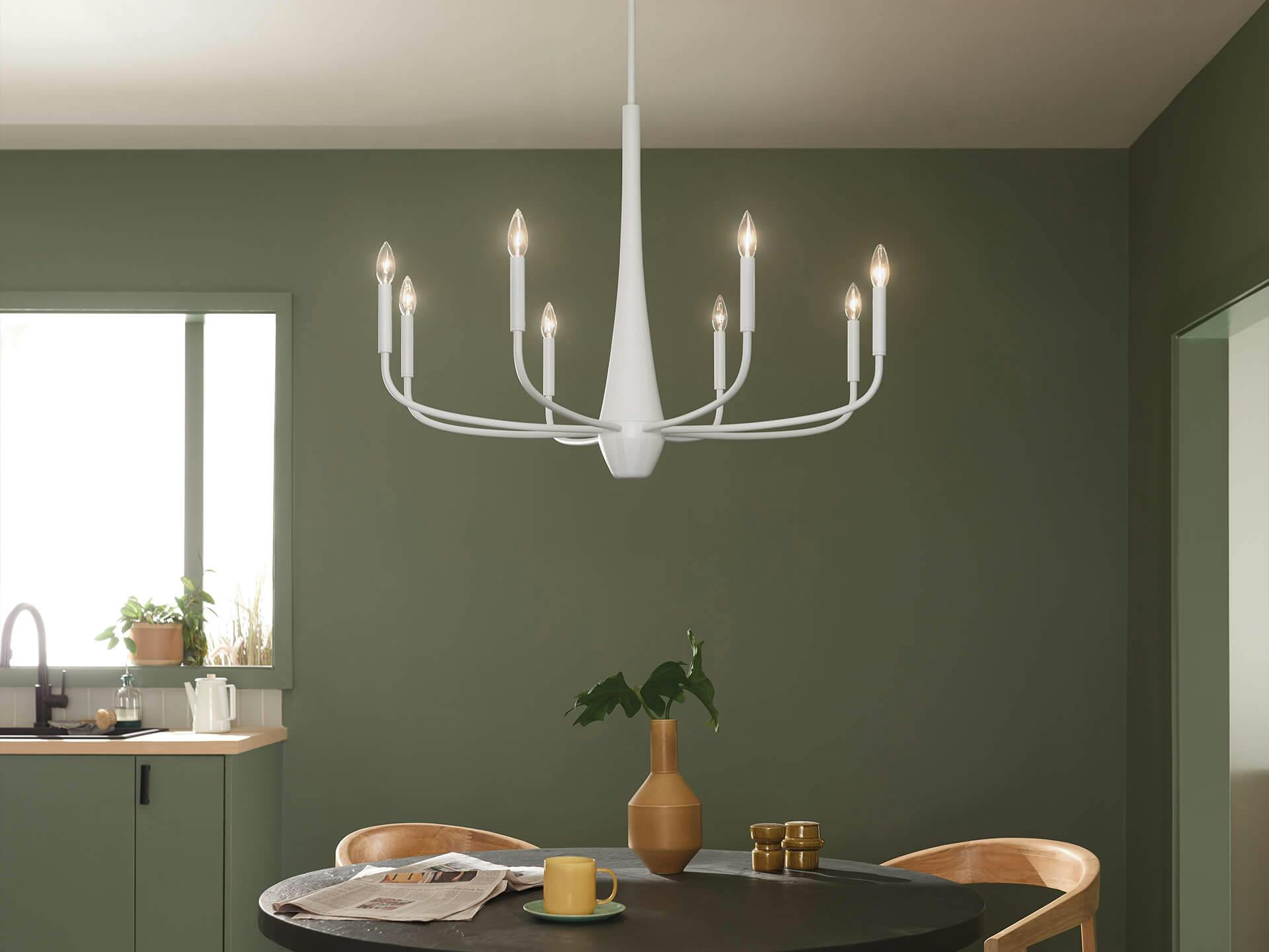 Green dining room with 8-light Deela chandelier in white hanging above the table