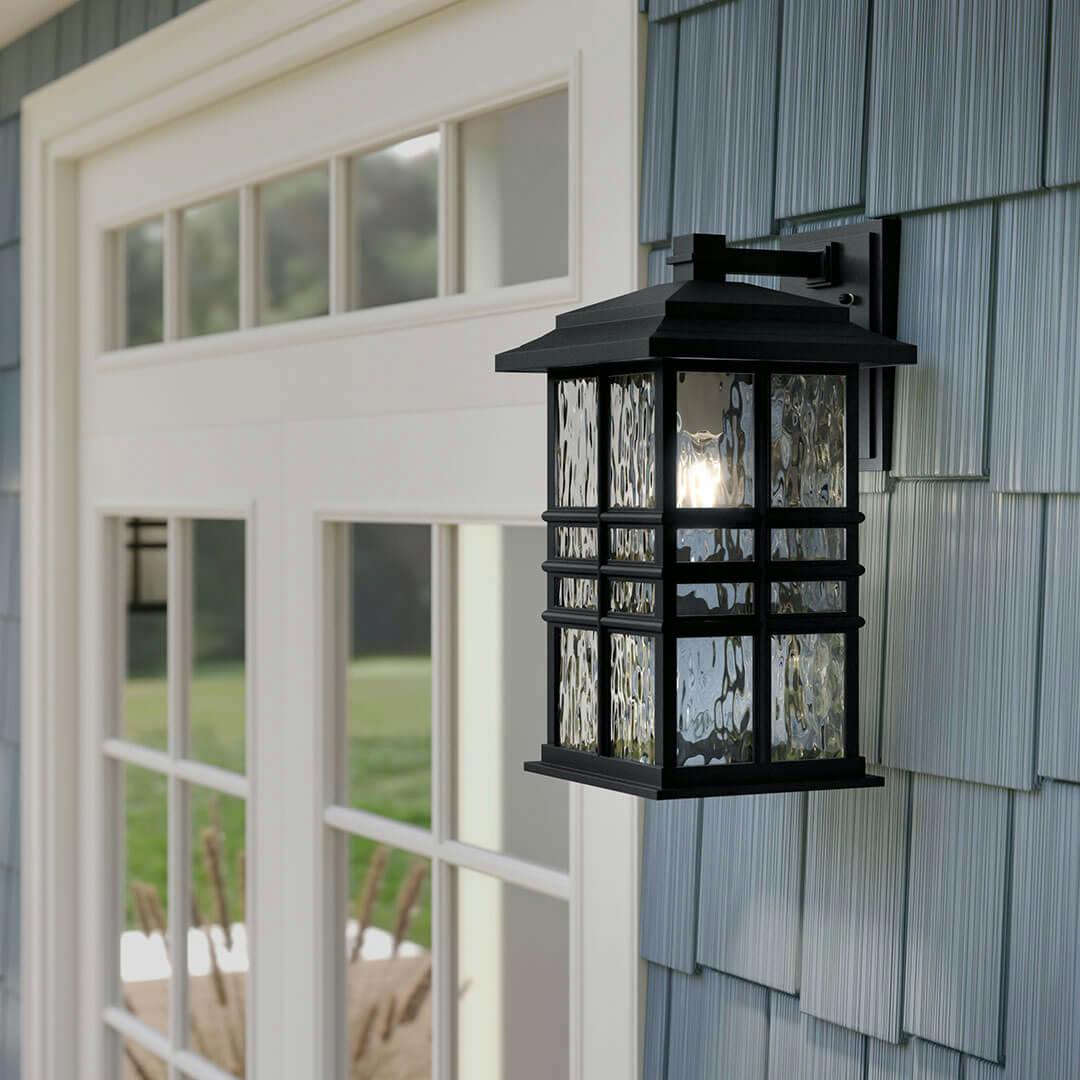 Day time view of the Beacon Square 17.5" 1-Light Outdoor Wall Light in Textured Black on the porch of a home