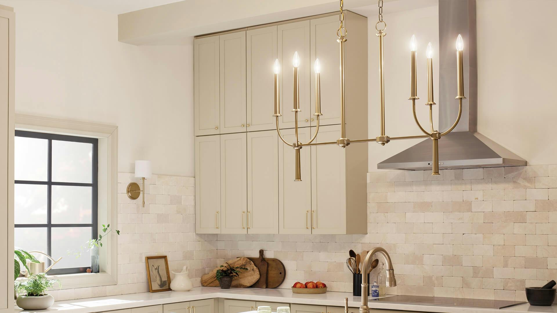 Beige ktichen with Florence 6-light chandelier in brushed natural brass hanging over the island