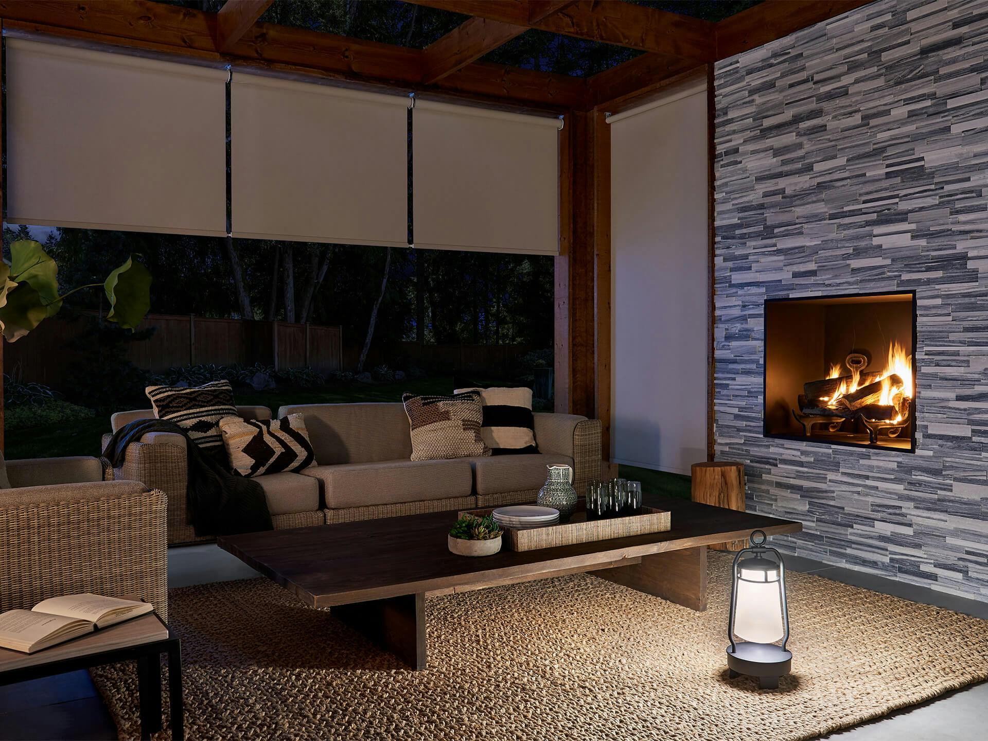 Cozy modern patio with a fireplace and Lyndon lantern on the ground