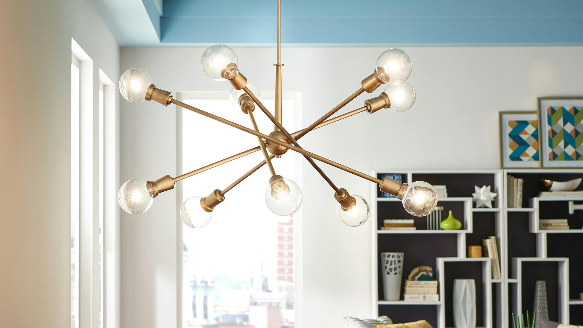 Armstrong 10-light chandelier with natural brass finish in dining room.