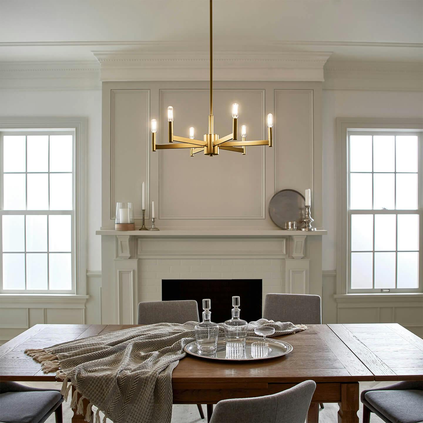 Bright dining room with Erzo chandelier and tube light bulbs