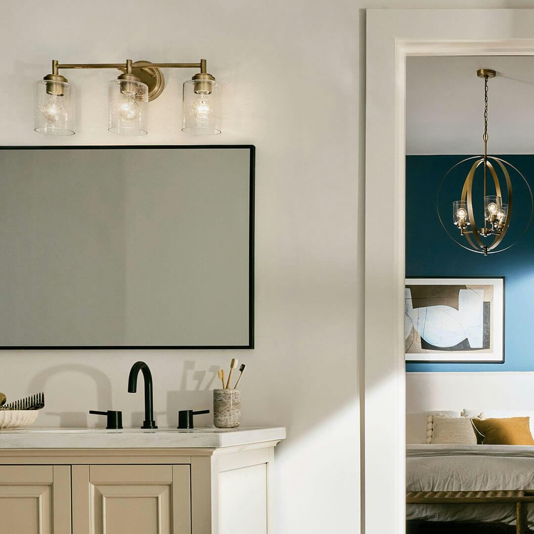 Bedroom in day light with the Winslow 21.5" 3-Light Vanity Light in Natural Brass