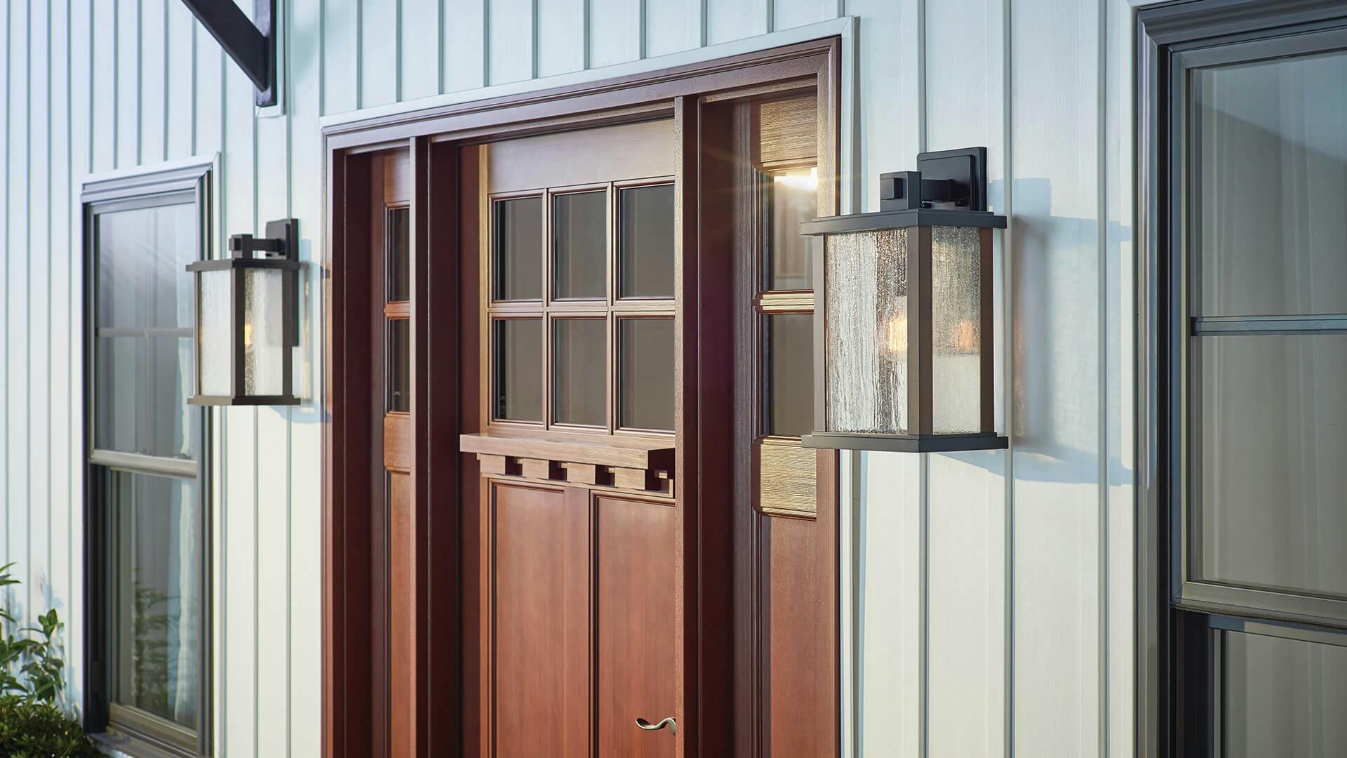 Outdoor view of an entry way featuring two marimount sconces on either side of the front door