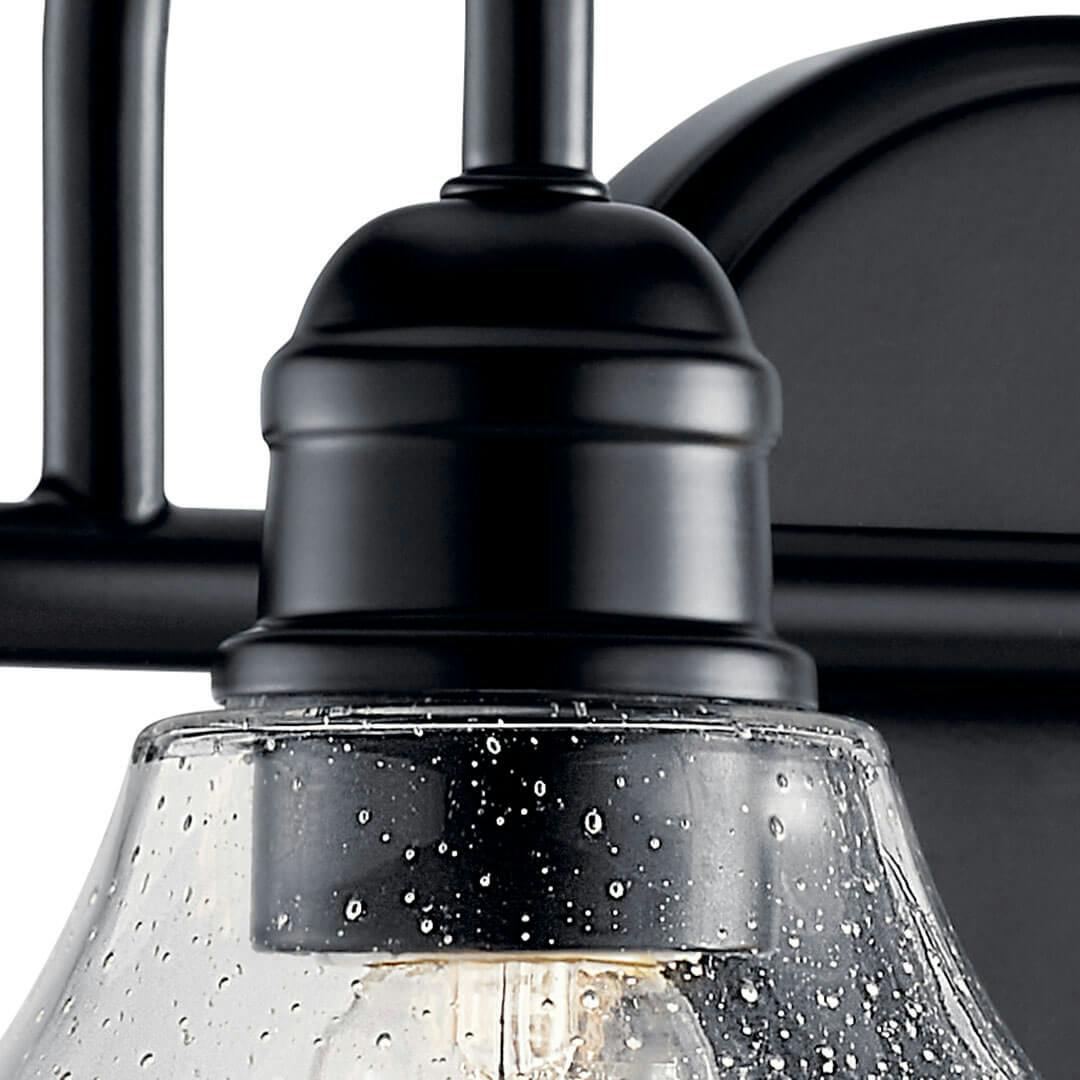 Close up of the Avery 15 Inch 2 Light Vanity Light with Clear Seeded Glass in Black on a white background