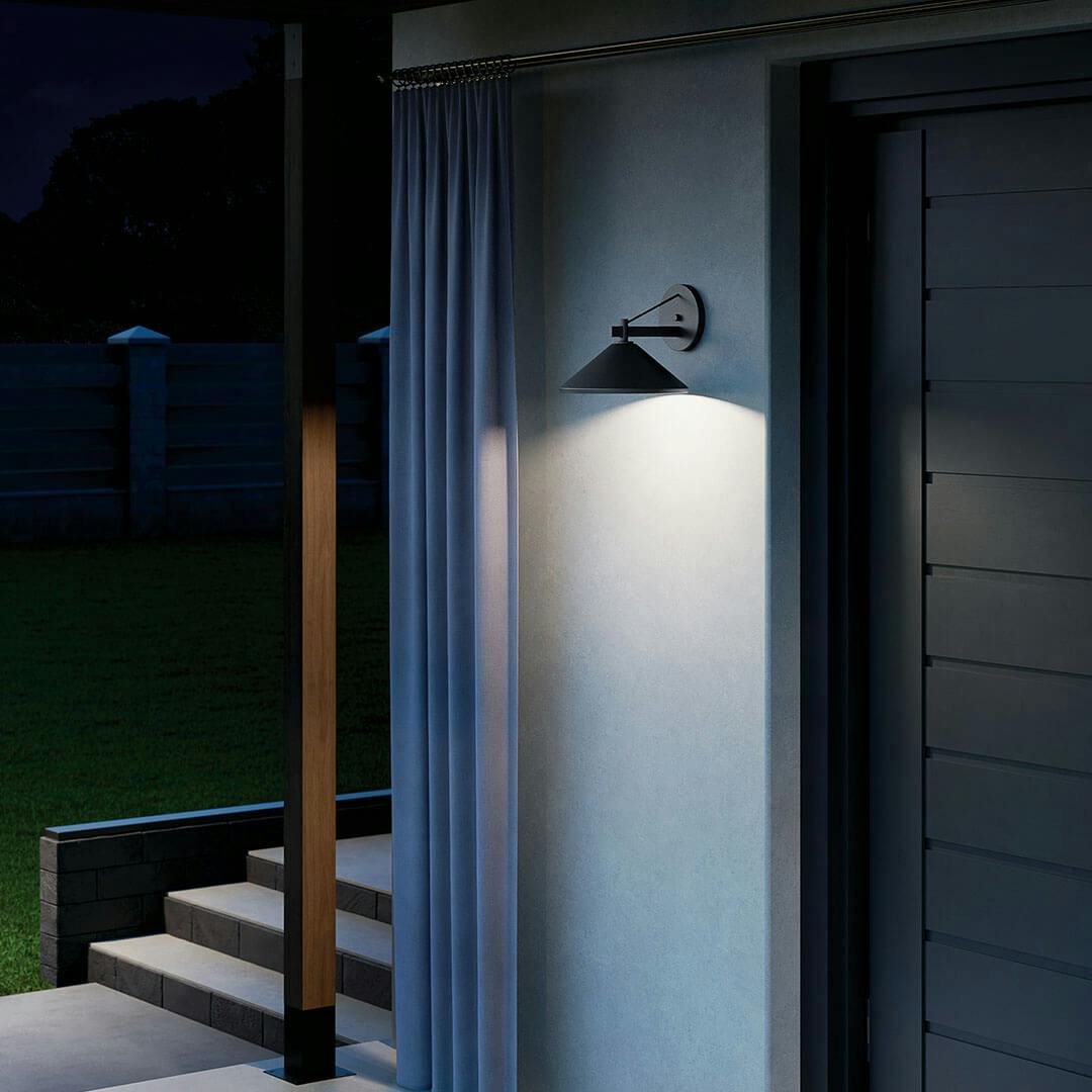 Porch at night with the Ripley 12" 1-Light Outdoor Wall Light in Black