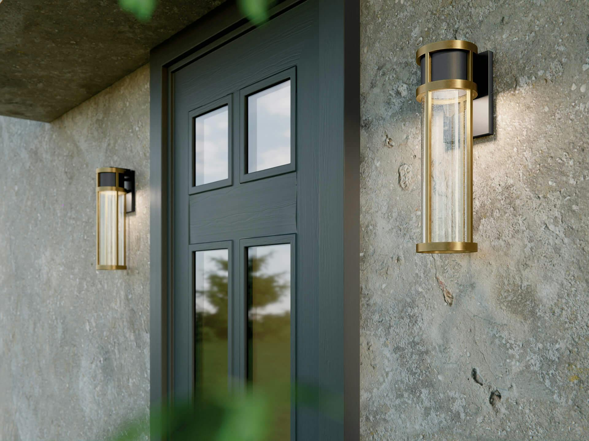 Two camillo black and gold wall sconces outside of an exterior entryway