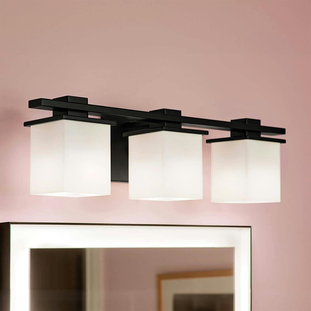 Bathroom in day light with the Tully 24" 3-Light Vanity Light in Black