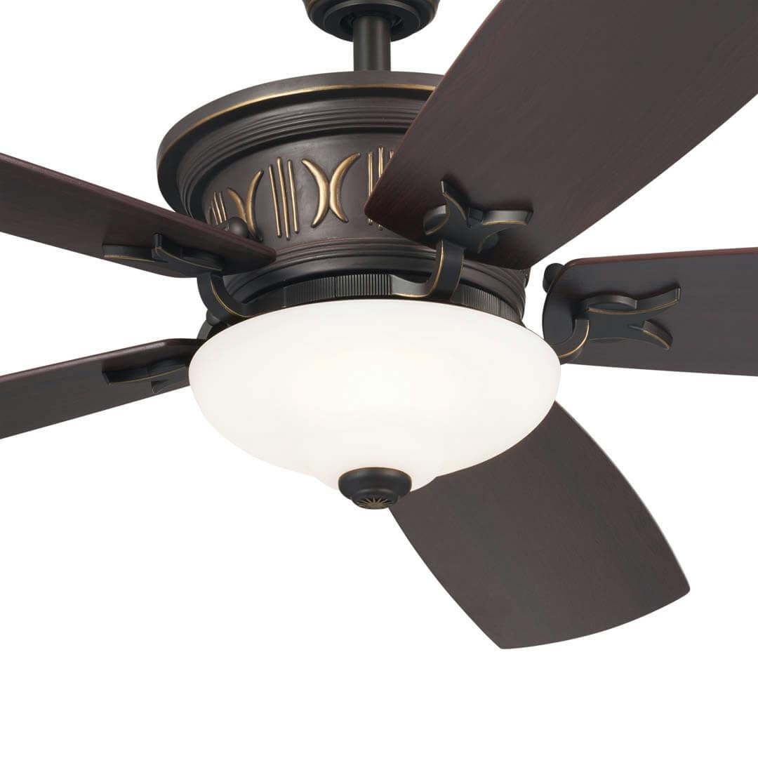 Close up product image of a walnut ceiling fan in bronze.