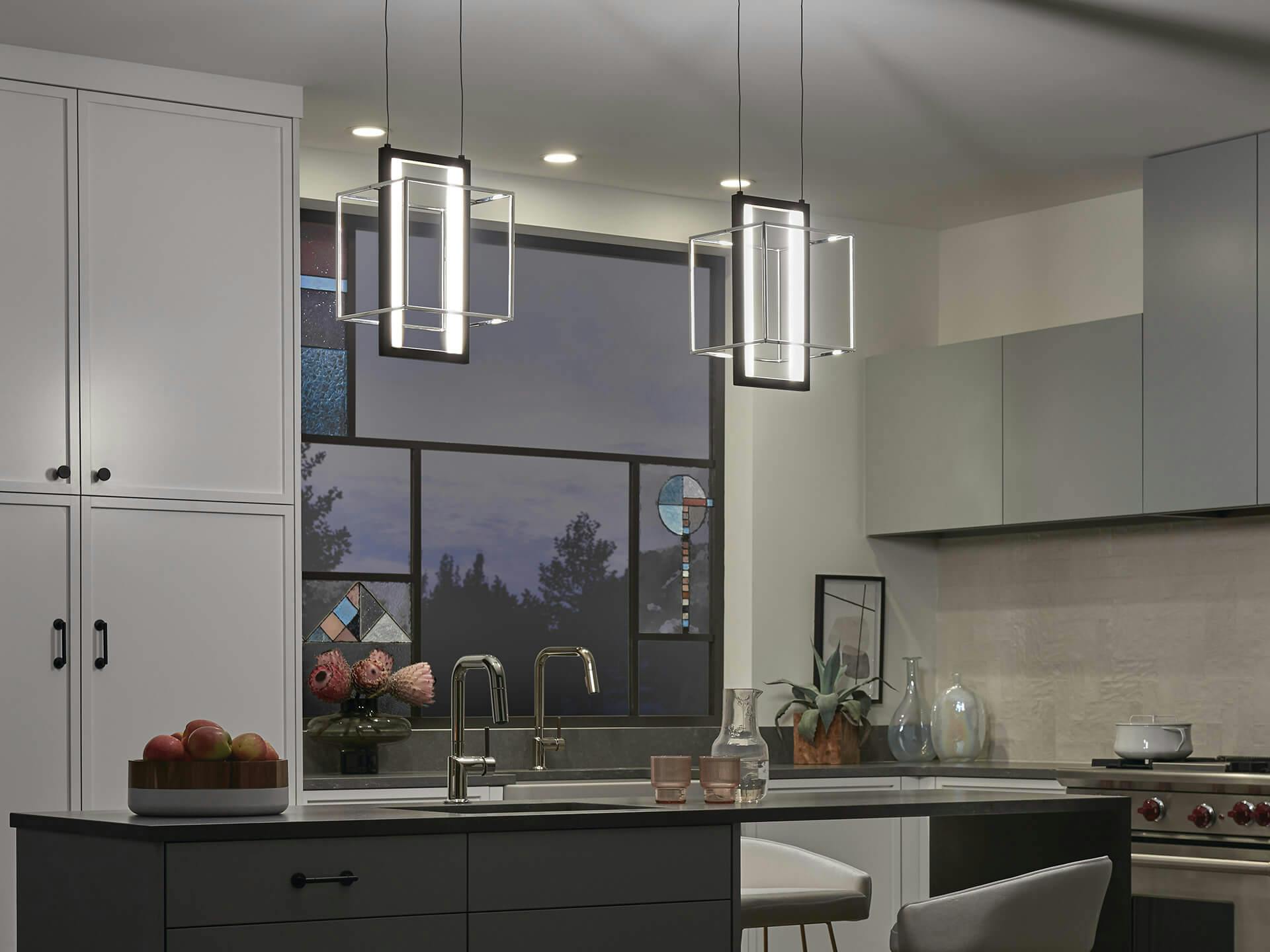 Modern kitchen at night with two Viho pendant lights hanging above a kitchen island