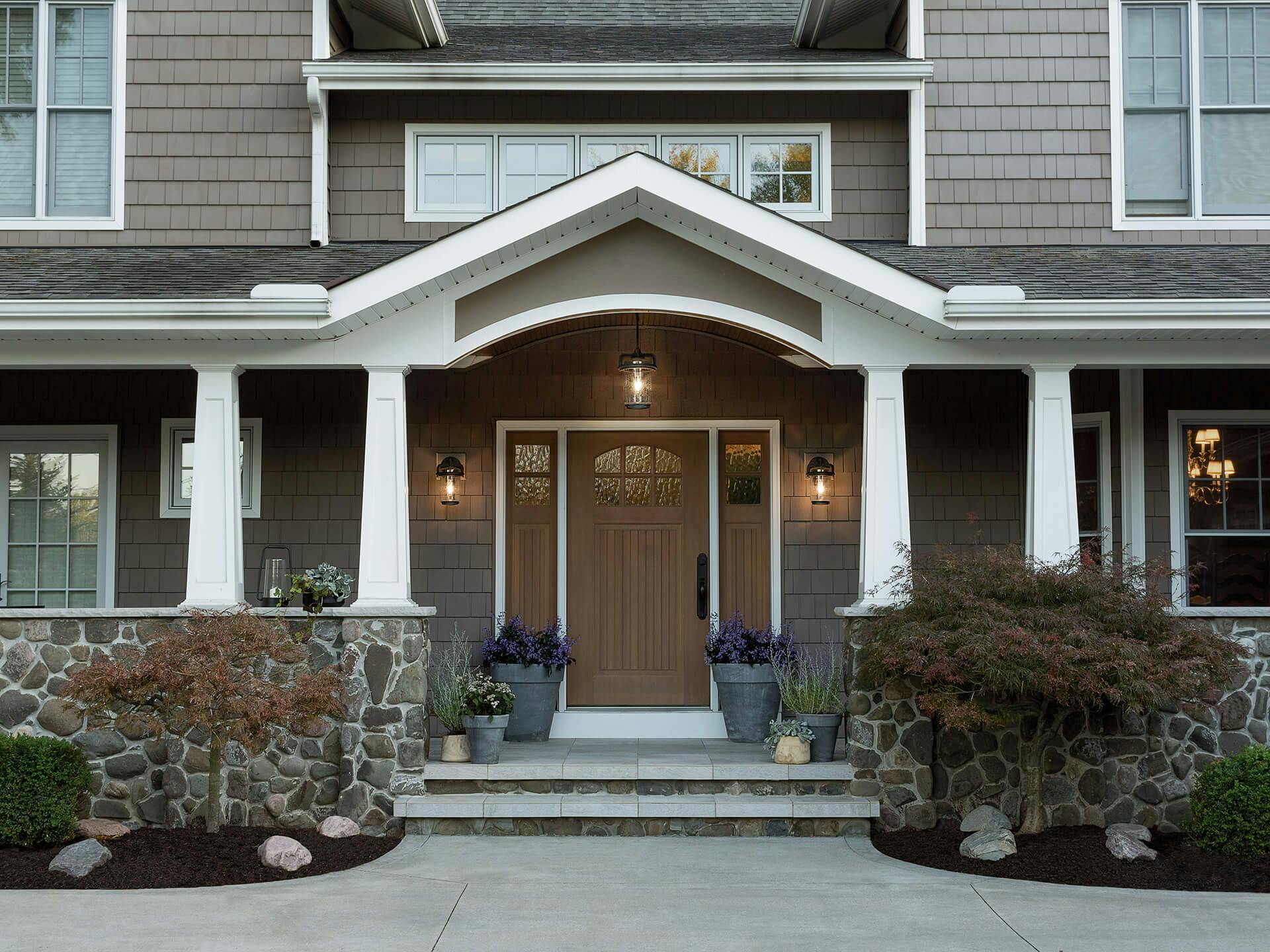 Front porch entryway of a home with three andover lights