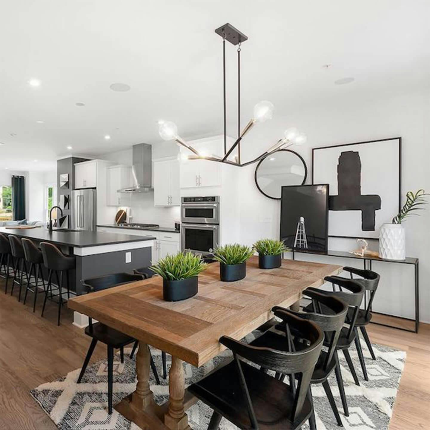 Dining room in modern kitchen with chandelier over table