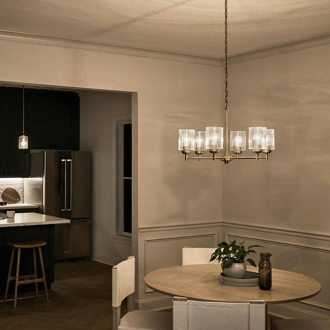Kitchen at night with the Winslow 16.5" 6-Light Chandelier in Natural Brass