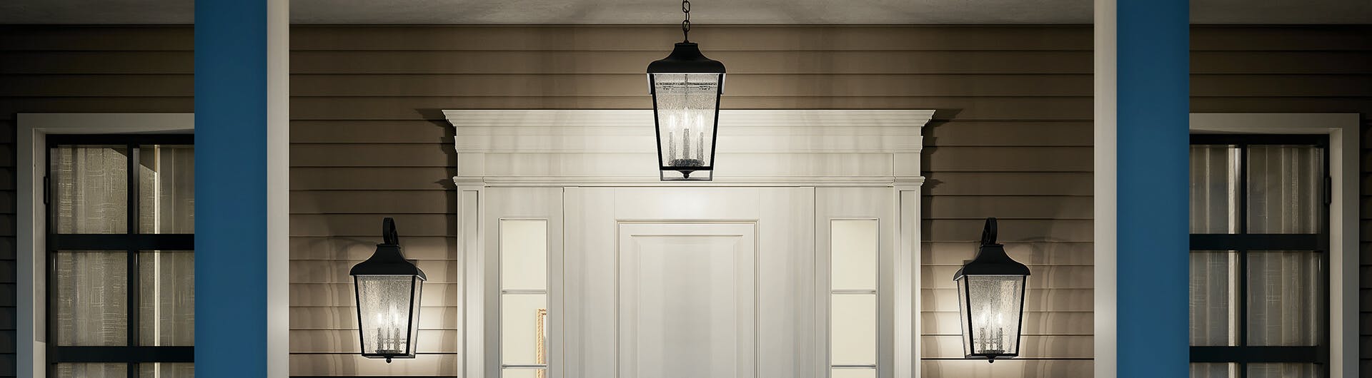 Entryway with three 4-light Forestdale hanging pendants in black illuminating the door