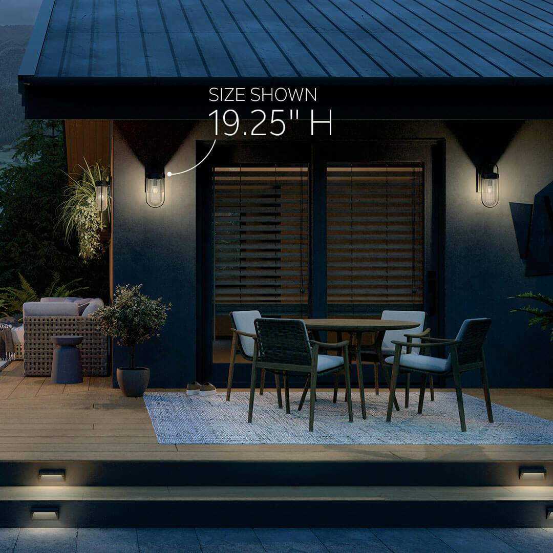 Deck at night featuring the Brix 19.25" 1 Light Outdoor Wall Light with Ribbed Clear Glass in Textured Black