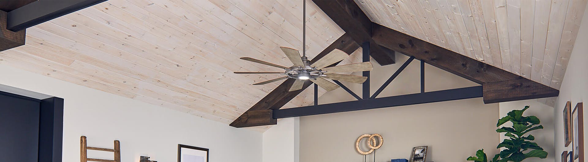 Barn style living room with a Gentry ceiling fan turned on during the day