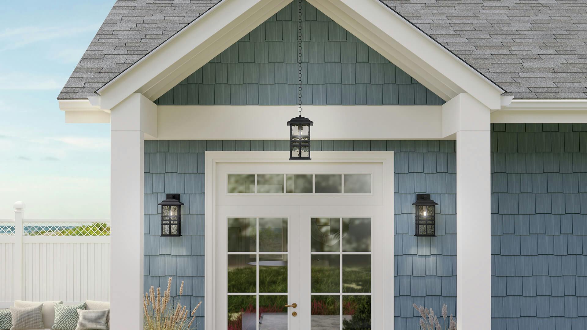 Porch of a blue beach house with three Beacon Square wall sconce lights and pendant in black finish