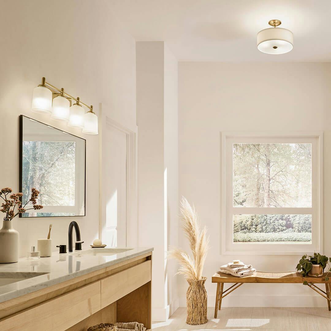 Bathroom in day light with the Shailene 29.75" 4-Light Vanity Light in Natural Brass