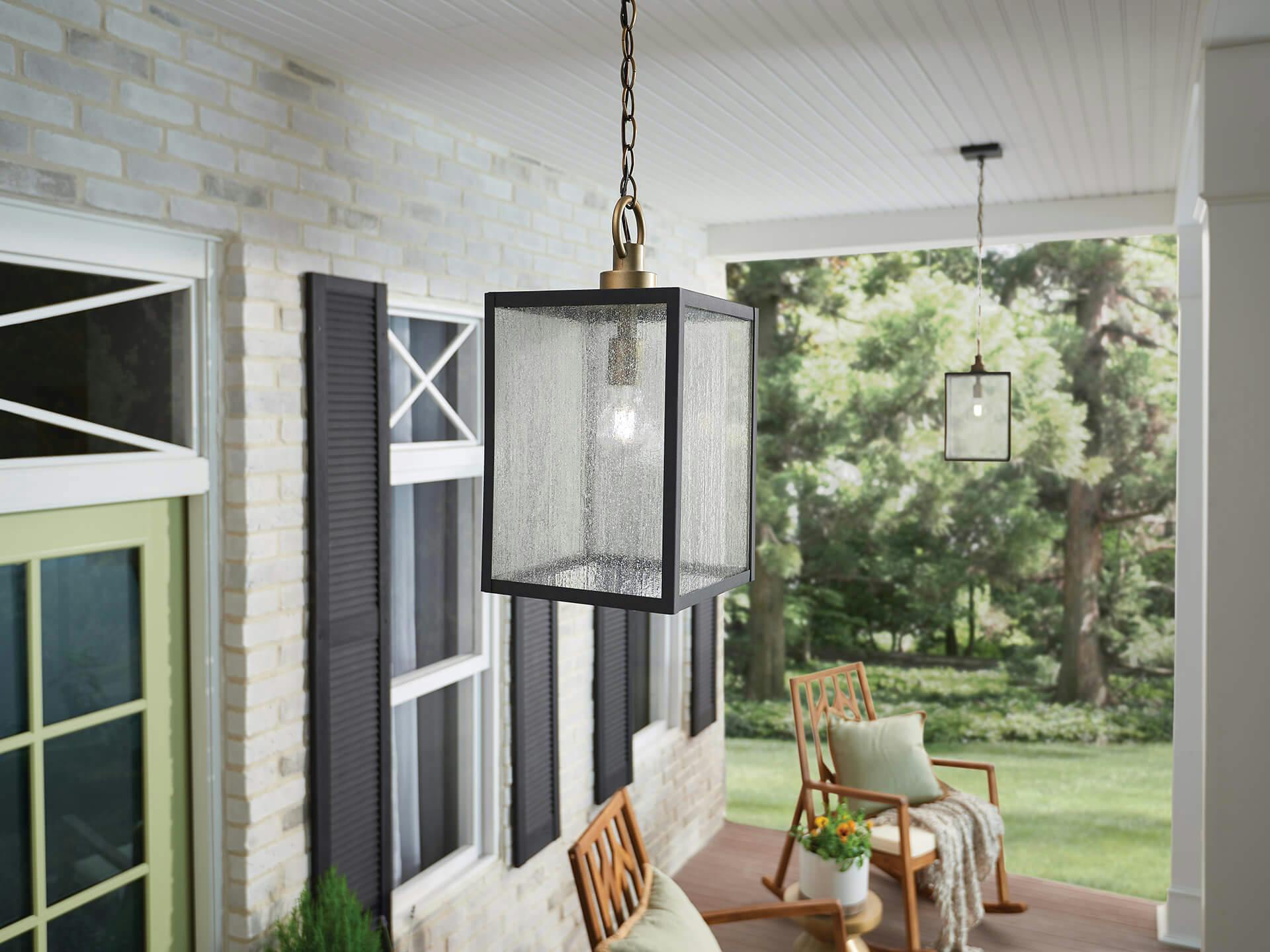 Porch scene with a close-up on two lit Lahden pendants hung in a row