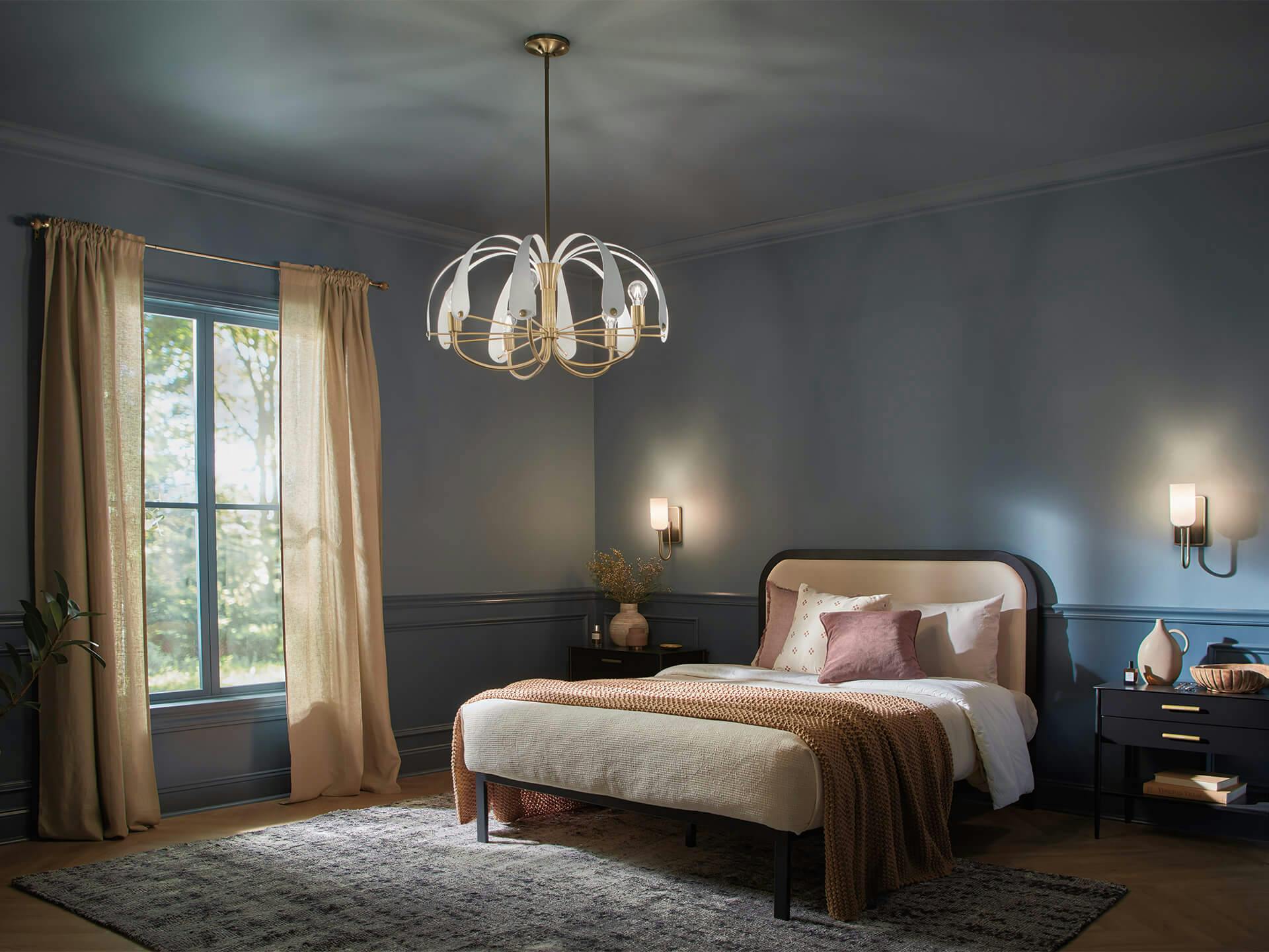 Dark blue bedroom with bed and nightstands and a Petal Chandelier in champagne bronze and white