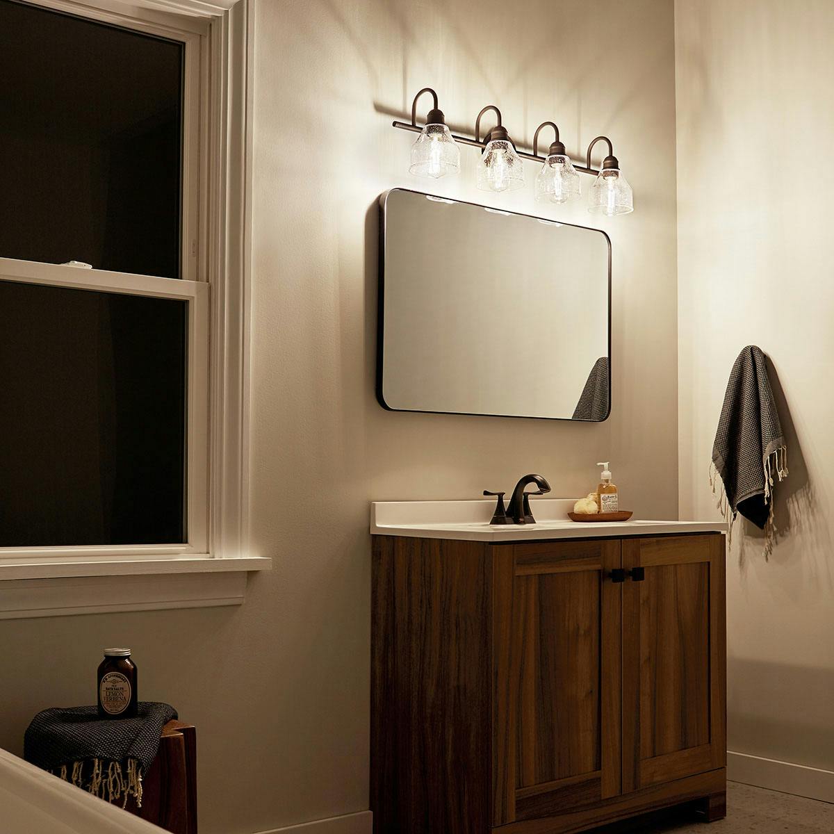 Night time Bathroom featuring Avery vanity light 45974OZ