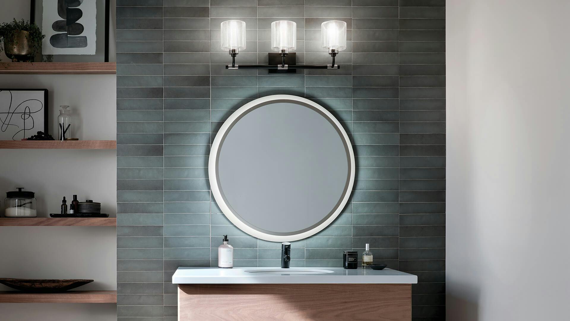 Bathroom with round LED mirror and Harvan black finish sconce above the mirror