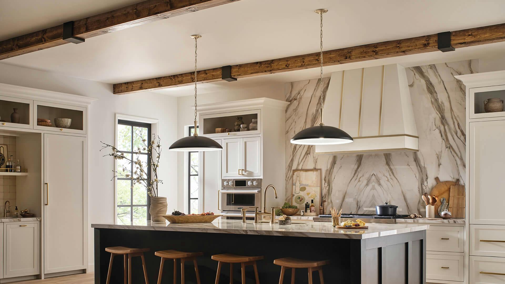 Two black Delarosa pendants hanging above a black island with marble counters