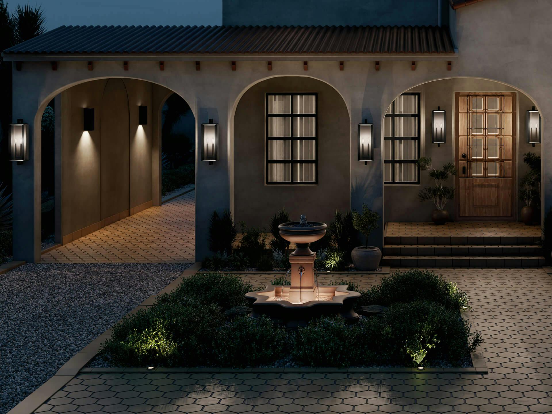 Exterior of a large home with fountain featuring various Kroft wall sconces