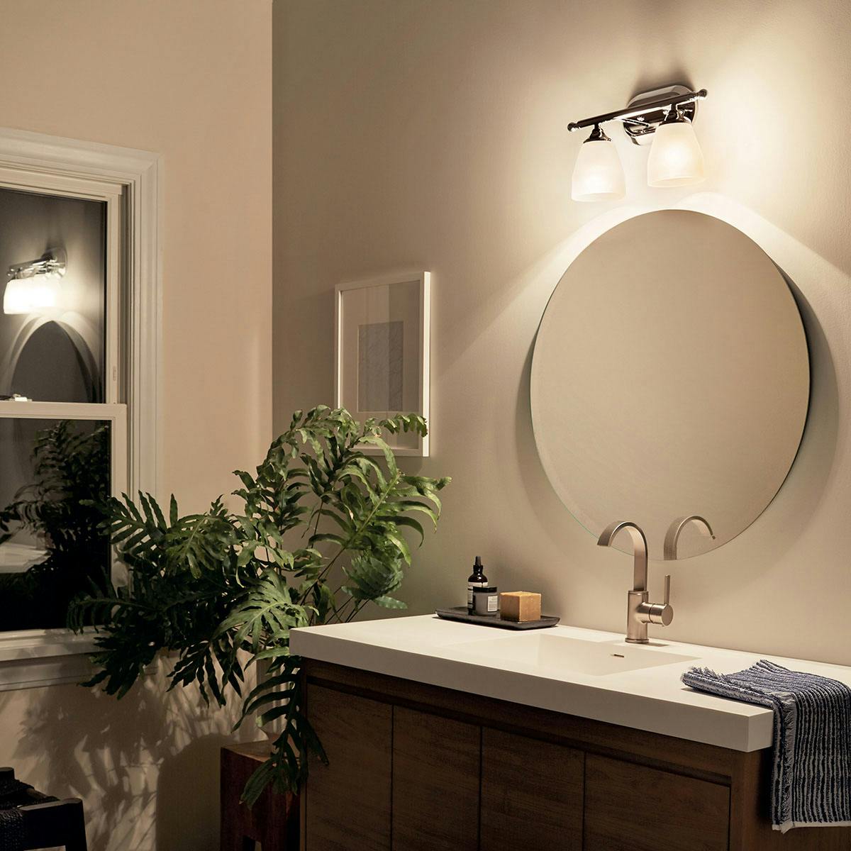 Night time Bathroom featuring Ansonia vanity light 5447CH