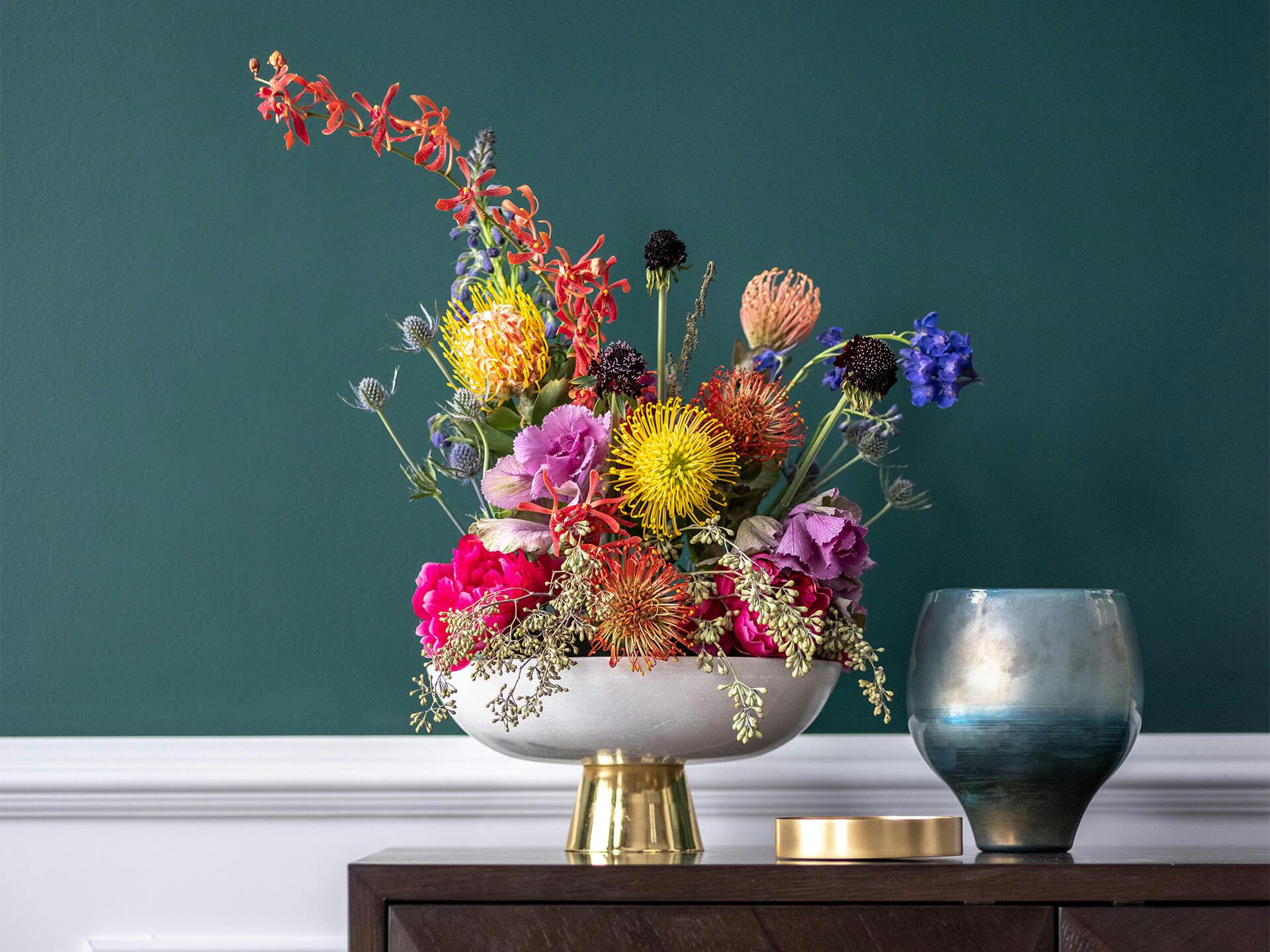 Colorful flowers in gold vase.