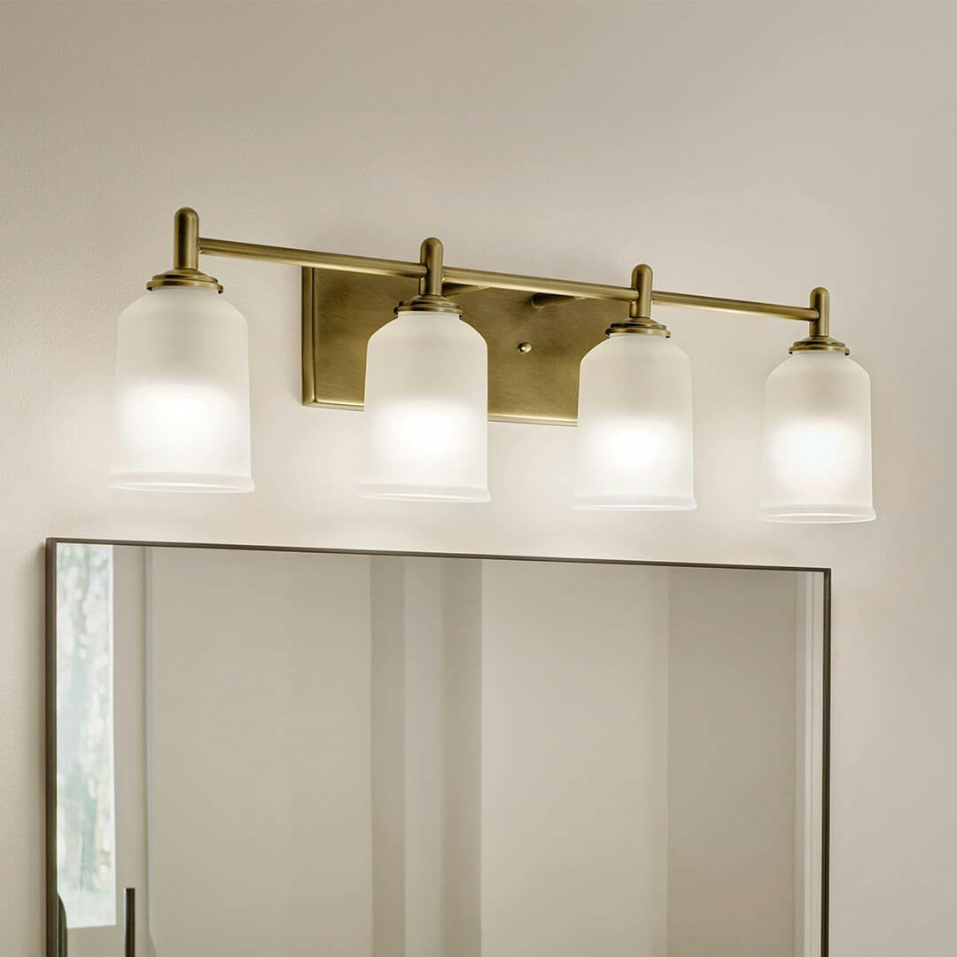 Bathroom in day light with the Shailene 29.75" 4-Light Vanity Light in Natural Brass