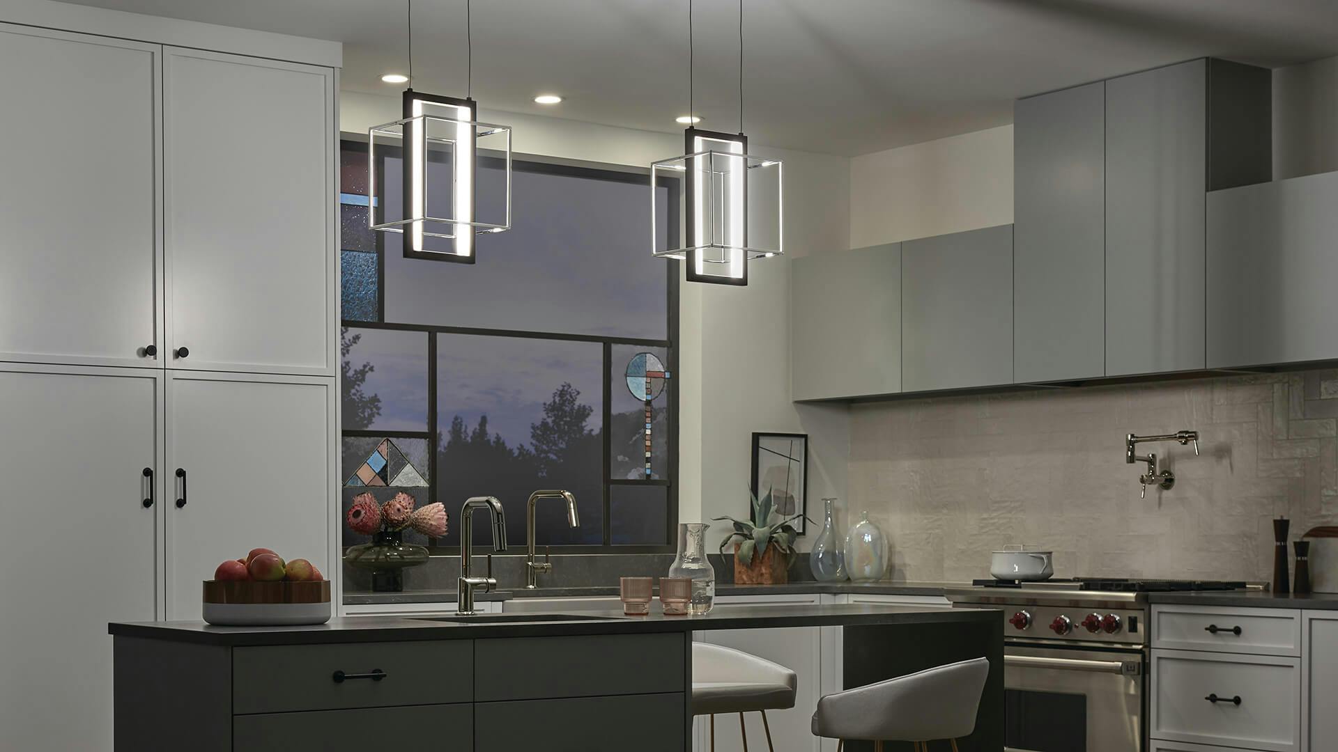 Modern kitchen at night with two Viho pendant lights over a kitchen island.