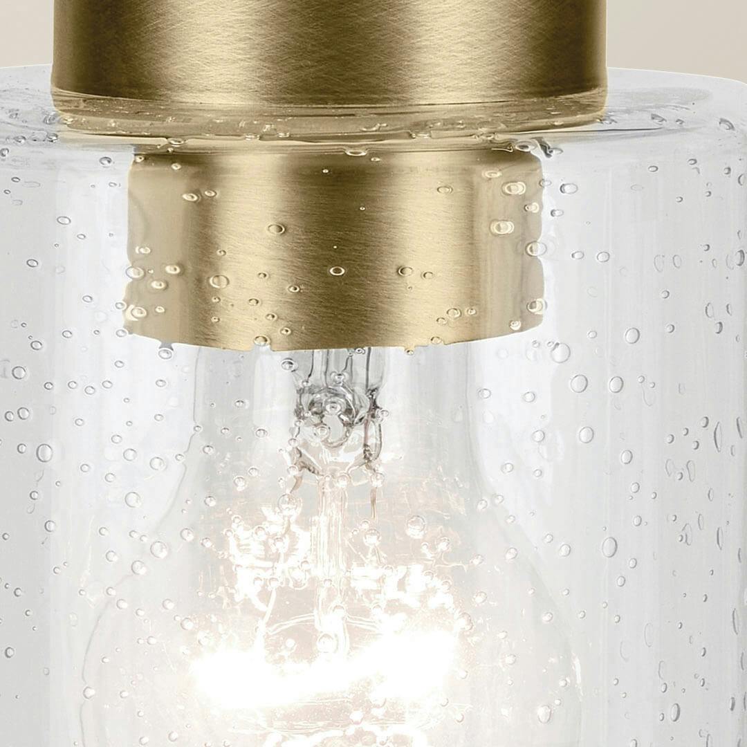 Close up view of the Winslow 7.5" 1-Light Mini Pendant Light with Clear Seeded Glass in Natural Brass