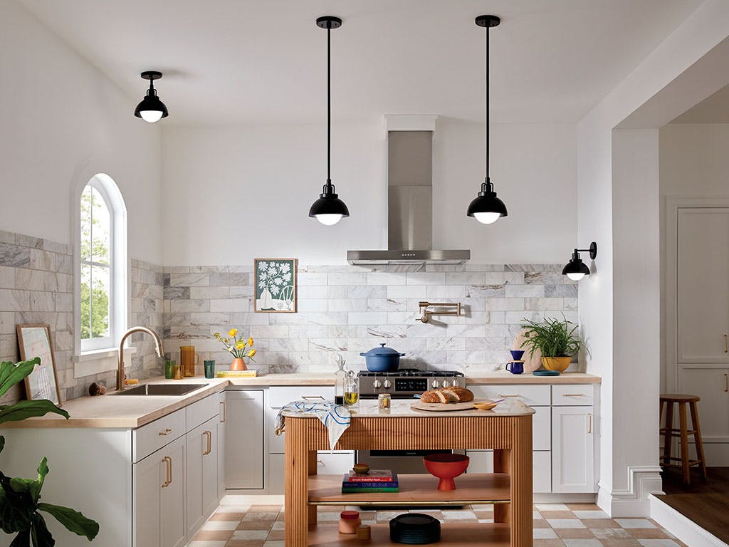 Modern white kitchen with black Niva Pendants hanging over work area