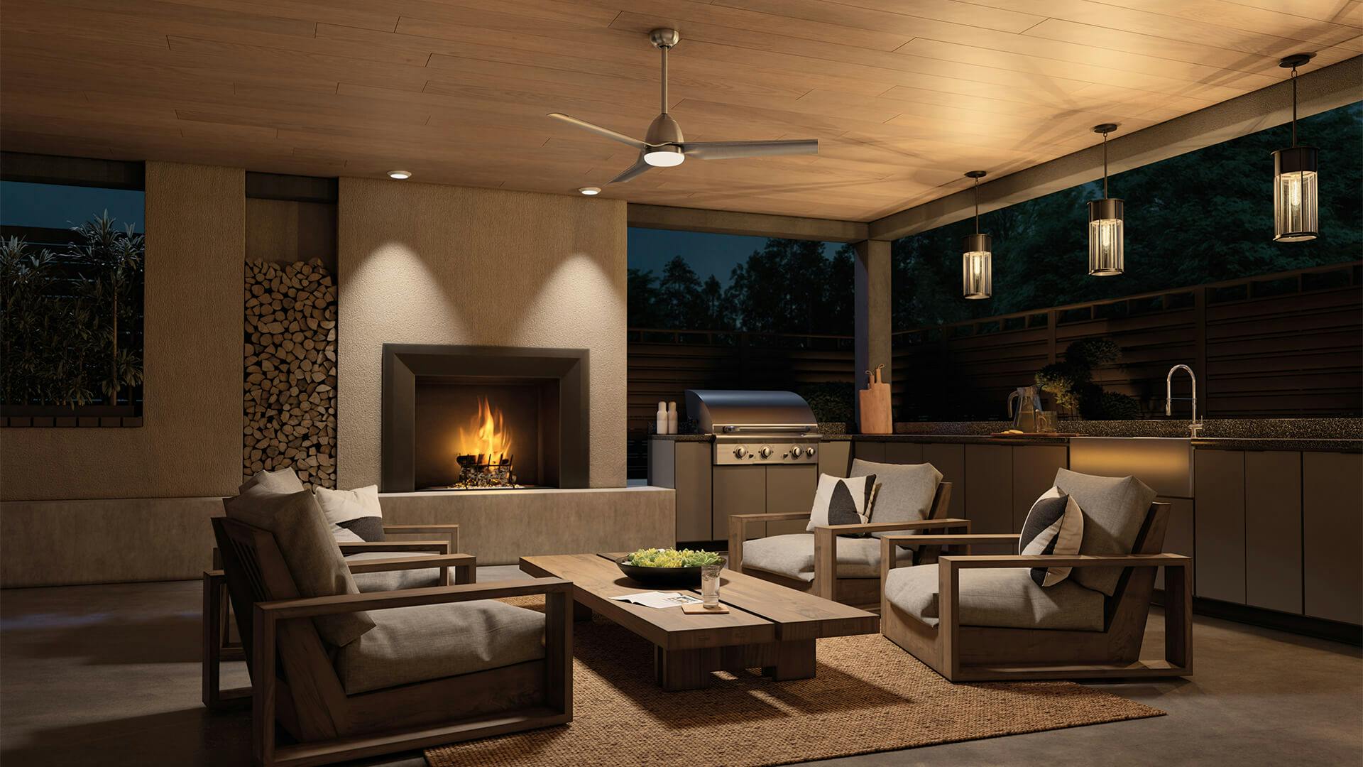 Covered patio with outdoor kitchen and lounge chairs and a Fit fan in nickel finish