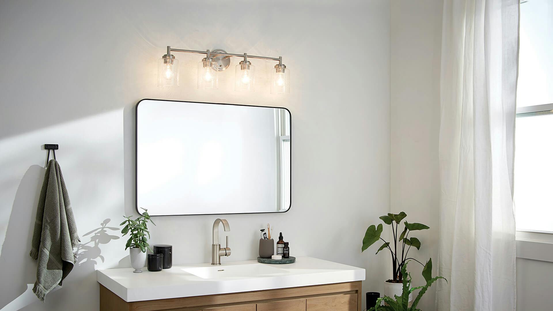 Winslow vanity light in brushed nickel in bathroom during the day.