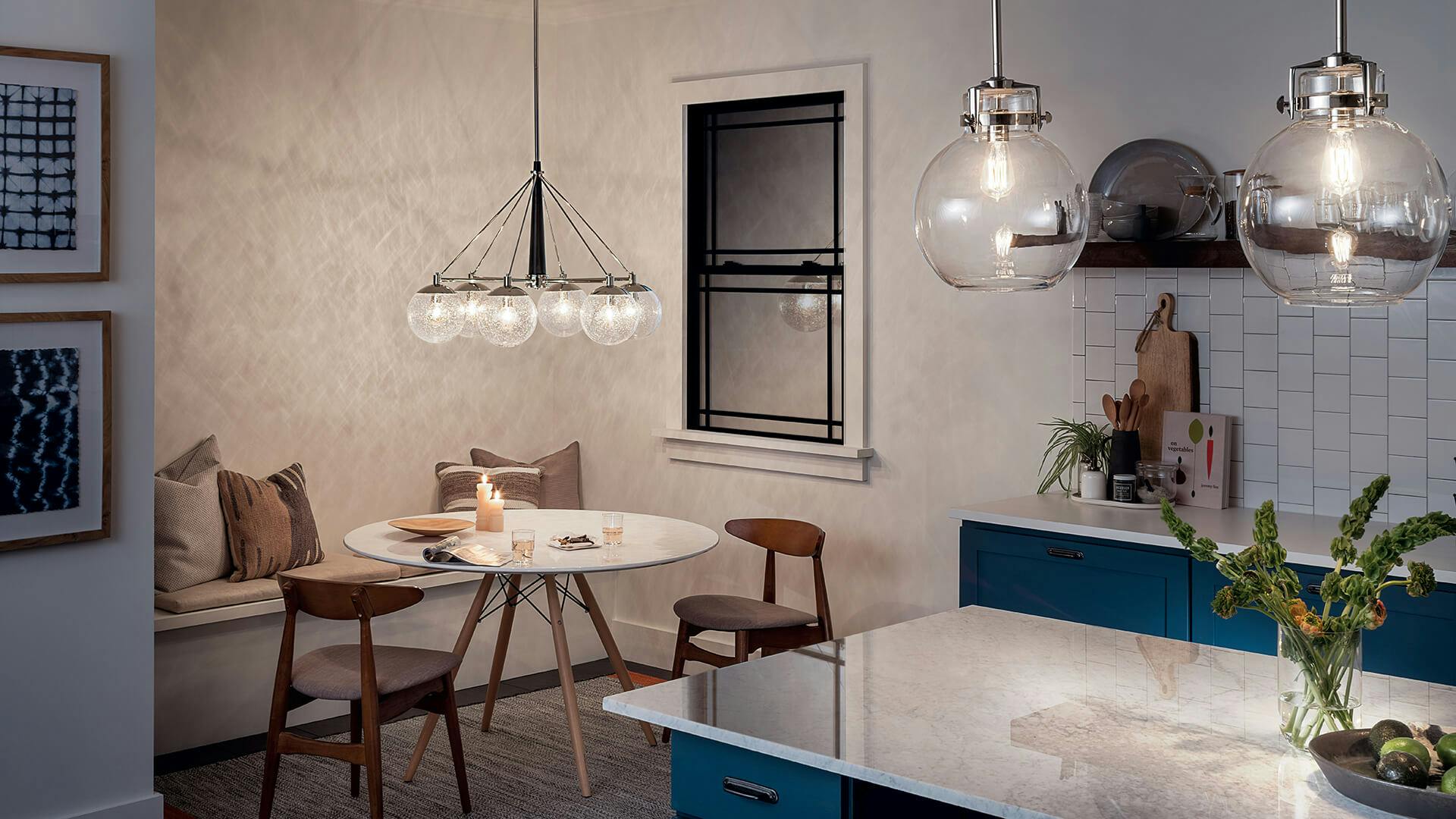 Kitchen in the evening with a nook style dining corner featuring Marilyn Briar chandelier and pendant lights at night