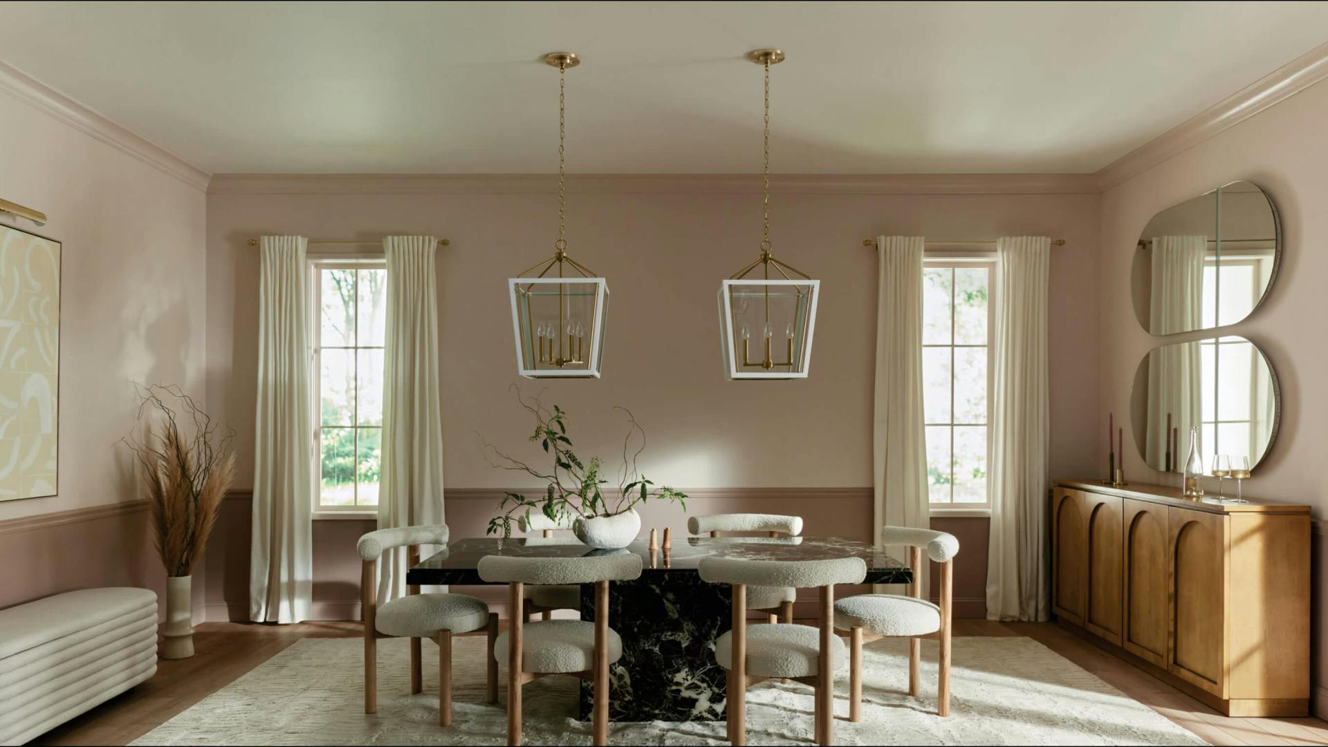 Dinning room with Delvin pendant lights, a Midi sconce, and a Radana mirror light, all turned off during the day 