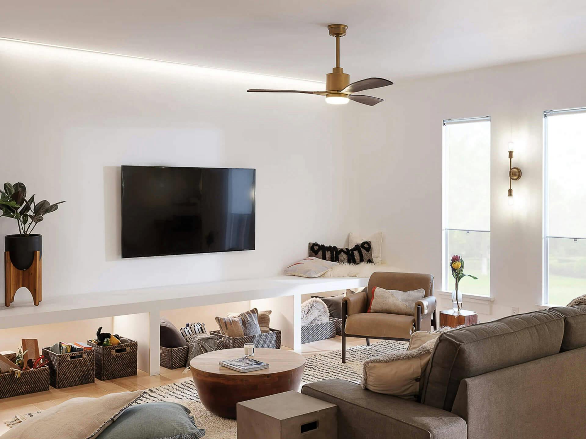 Living room accented with lighting from a Colerne ceiling fan and an Armstrong wall sconce
