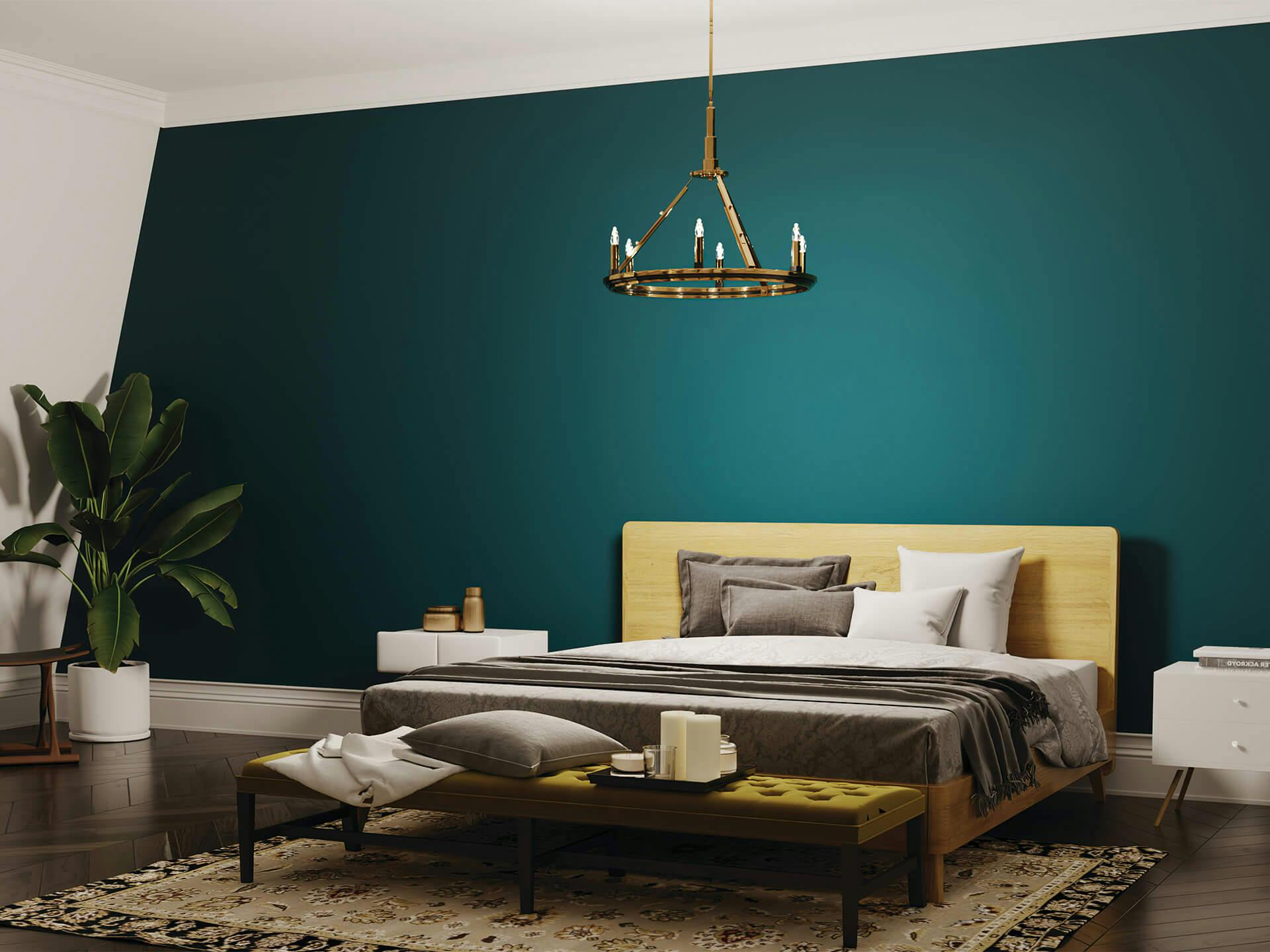 Bedroom with a green accent wall behind the bed with a Emmala chandelier hanging above