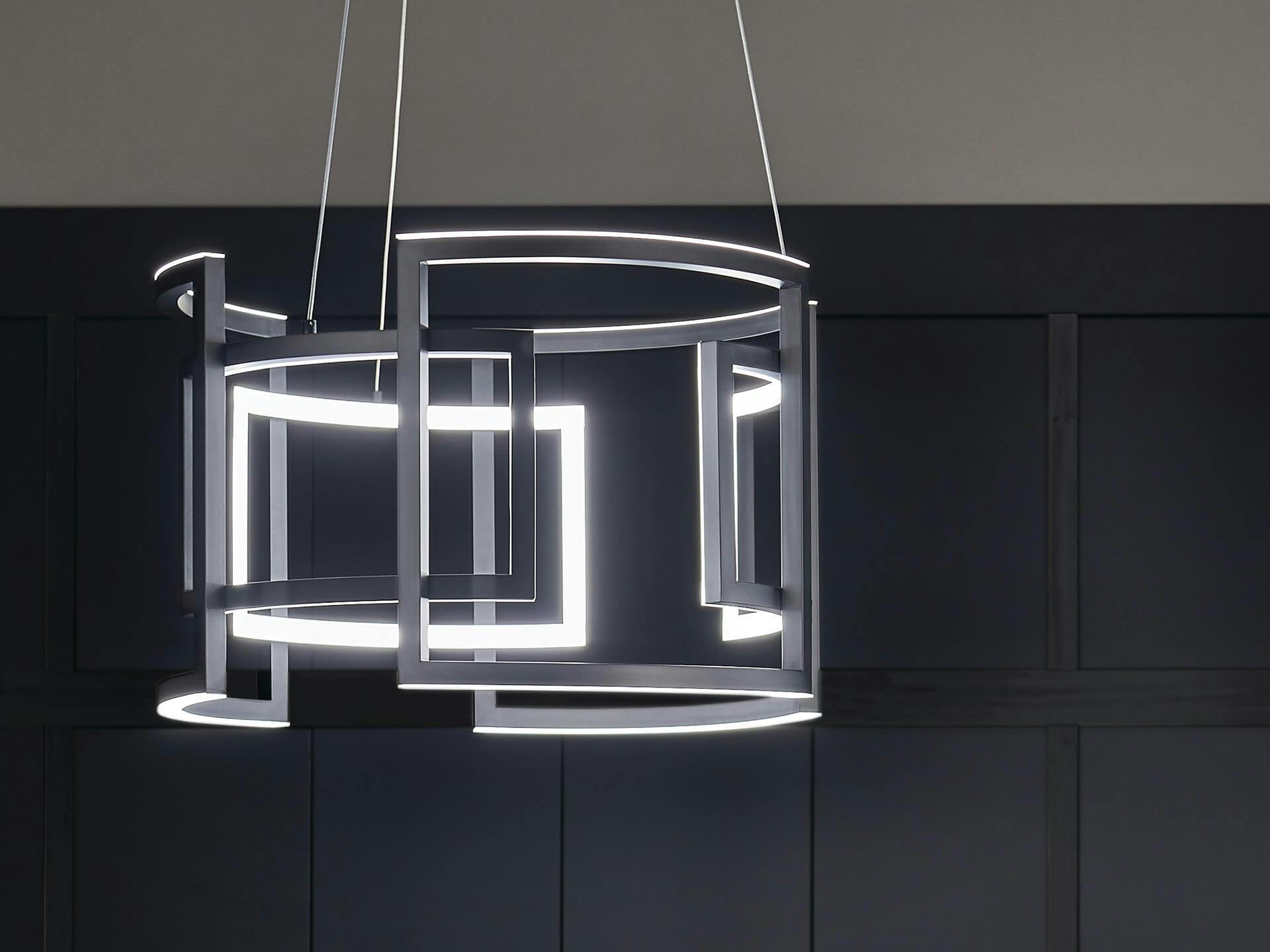 Close up of a Melko chandelier in black finish against and black and white wall