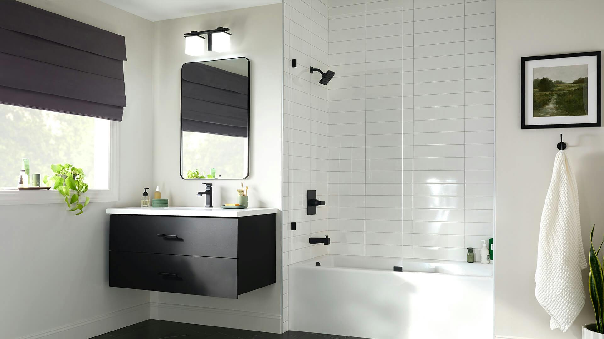 White tiled bathroom with Tully 2-light vanity light above the floating black vanity