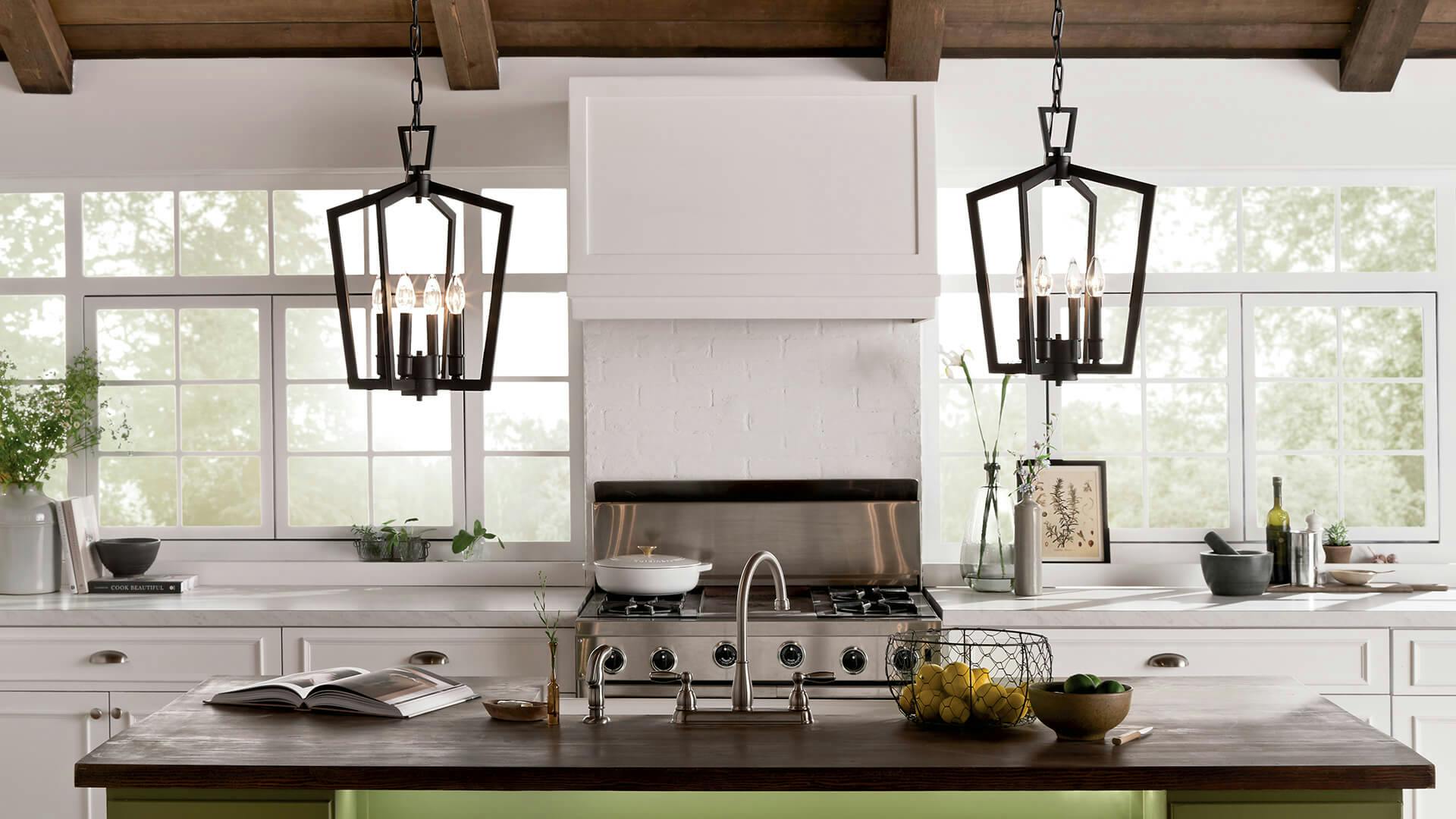 Rustic kitchen with white walls, green kitchen island, and Abbotswell pendant lamps in black finish